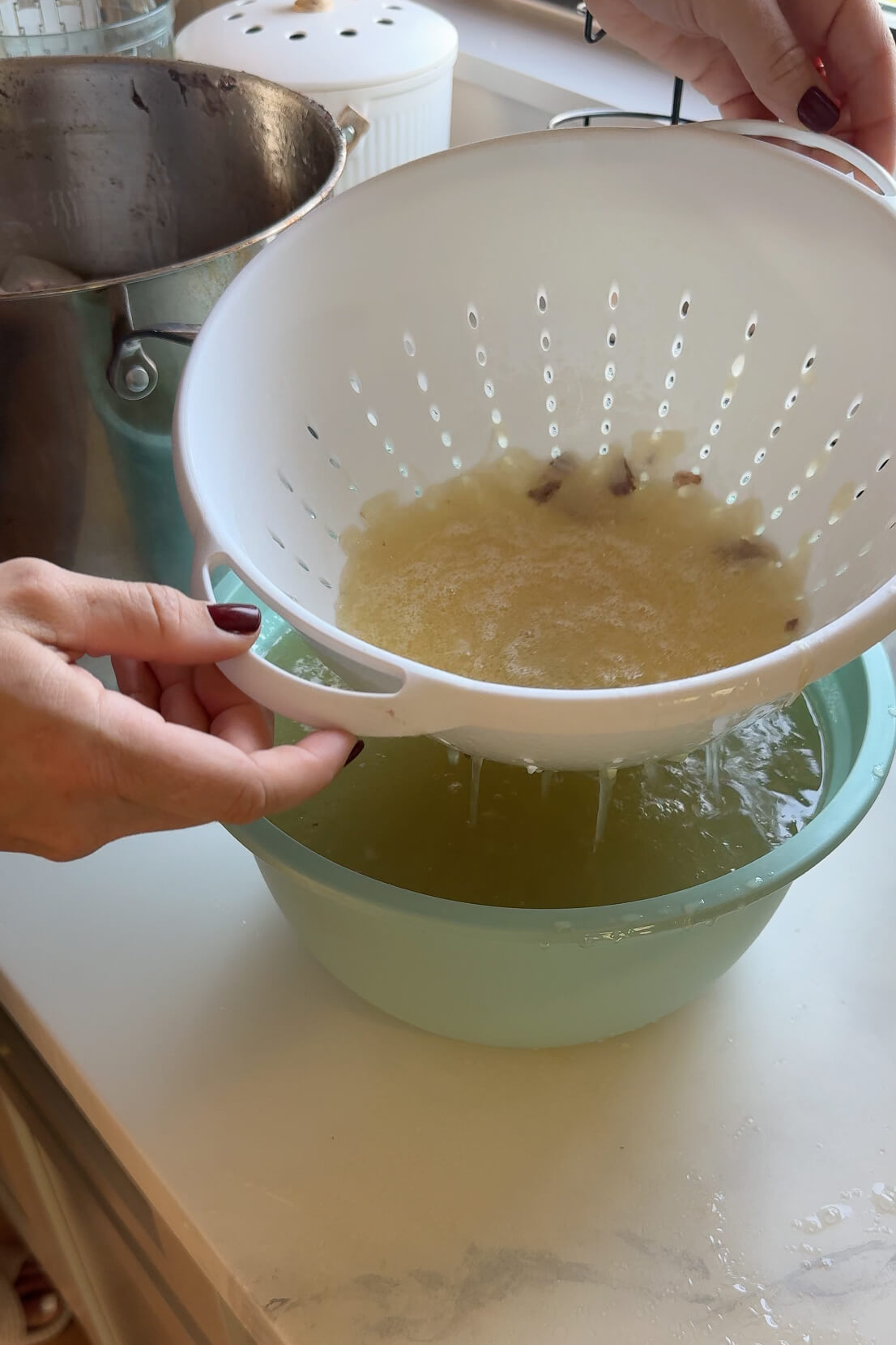 Straining chicken broth. 